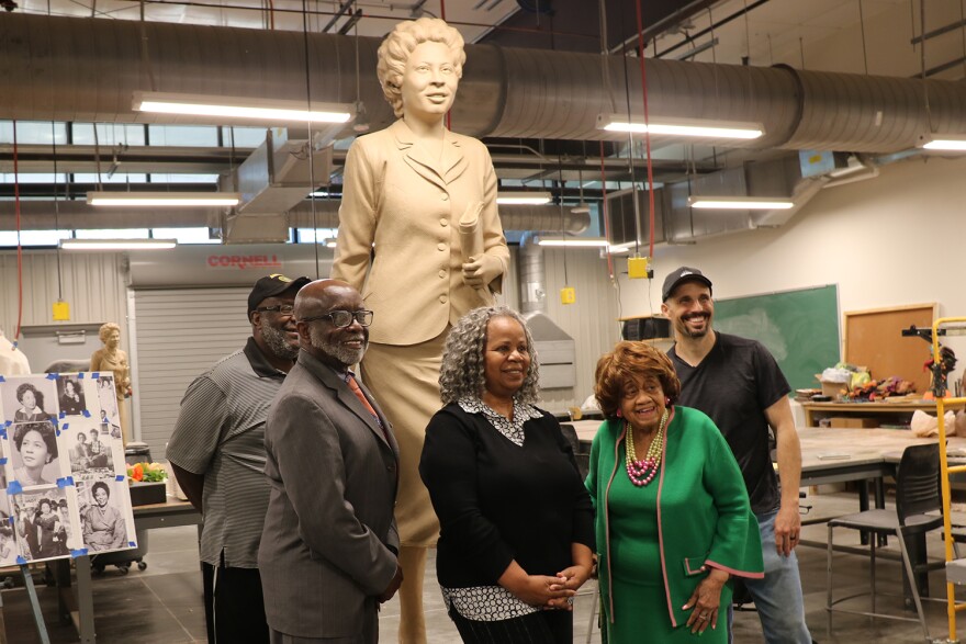 Charles King, Janis Kearney, Mary Louise Williams and sculptor Benjamin Victor pose for a photo in front of the clay model of Daisy Bates on Tuesday.