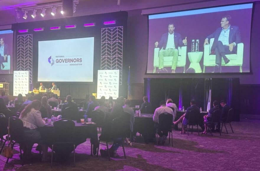 U.S. Homeland Security Secretary Markwayne Mullin speaks with Oklahoma Republican Gov. Kevin Stitt Saturday at the National Governors Association summer meeting in Oklahoma City. Mullin, a former U.S. senator from Oklahoma, urged states to cooperate with federal immigration arrests.