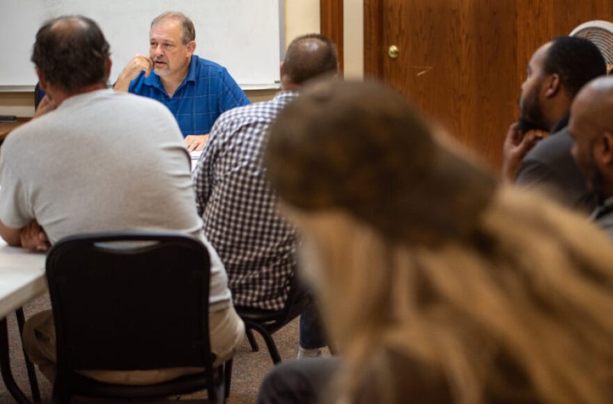 Forrest Britton, a batterer intervention facilitator at Catalyst in Oklahoma City, talks to a class of 14 men about commitments and relationships during a session on Oct. 22.