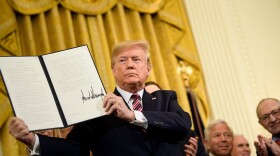 President Trump shows an executive order regarding anti-Semitism during a Hanukkah reception in the East Room of the White House, Dec. 11, 2019. (Brendan Smialowski/AFP via Getty Images)
