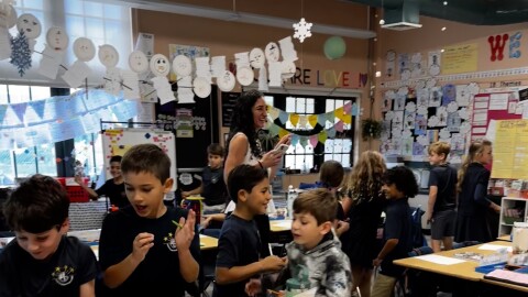 Melissa Abril-Dotel and her 2nd grade students play musical chairs in their classroom at North Beach Elementary School on Jan. 18, 2024