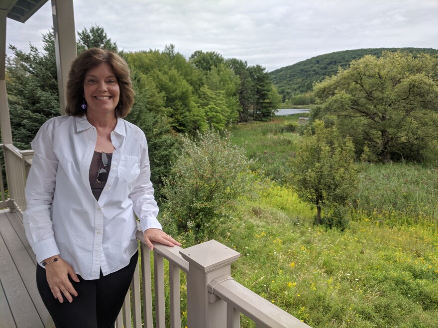 Molly Santa Croce overlooking Binghamton University's Nature Preserve, a place her daughter, Megan, loved to visit. A tree is planted here in Megan's honor. Sarah Gager/WSKG