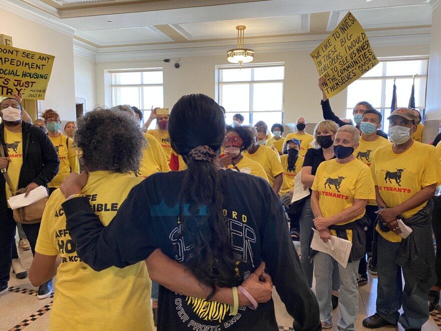 KC Tenants members embrace while singing a song before speaking to Mayor Lucas.