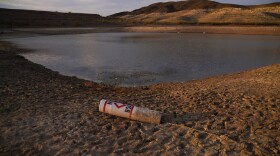 A buoy rests on the ground at a closed boat ramp on Lake Mead at the Lake Mead National Recreation Area, Friday, Aug. 13, 2021, near Boulder City, Nev. (AP Photo/John Locher)