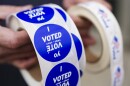 A poll worker holds voting stickers for community members Nov. 7, 2023, at Central Elementary School in Allentown, Lehigh County, Pennsylvania.