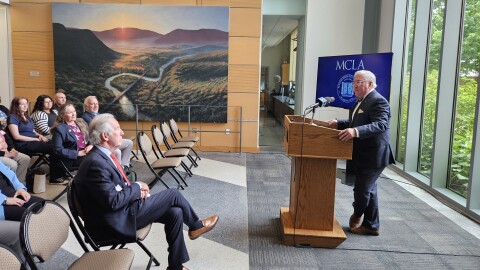 Massachusetts College Of Liberal Arts President Jamie Birge (standing at lectern), Congressman Richard Neal (seated in the front row), and MCLA board of trustees chair Buffy Lord (in the blue blazer and maroon shirt behind Neal).