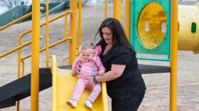 Roya White helps her daughter, Ember, down the slide at Lions Park in Midwest City. White shared her story with Oklahoma Watch in 2018. She says was fired from her waitressing job while pregnant with Ember.