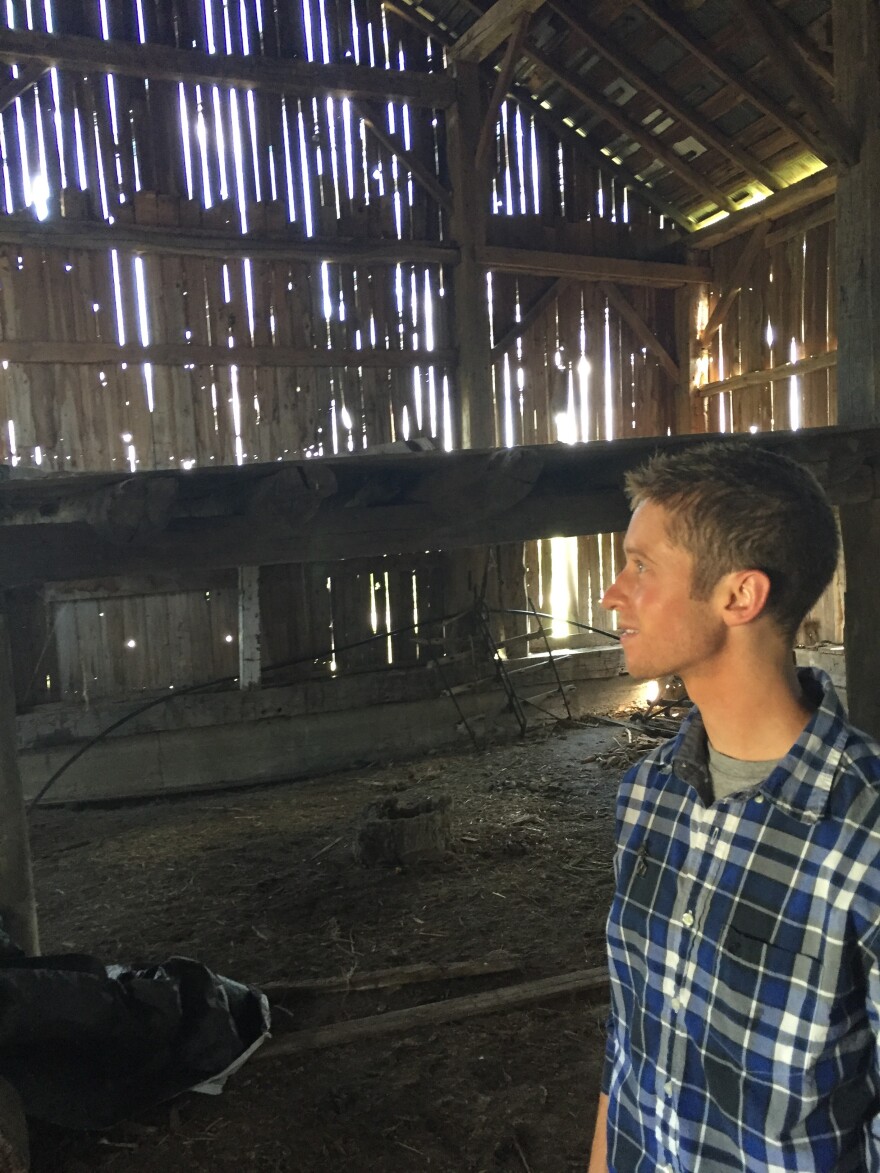 Connor Kaiser stands in the old barn, built as part of the James and Sophia Clemens homestead.