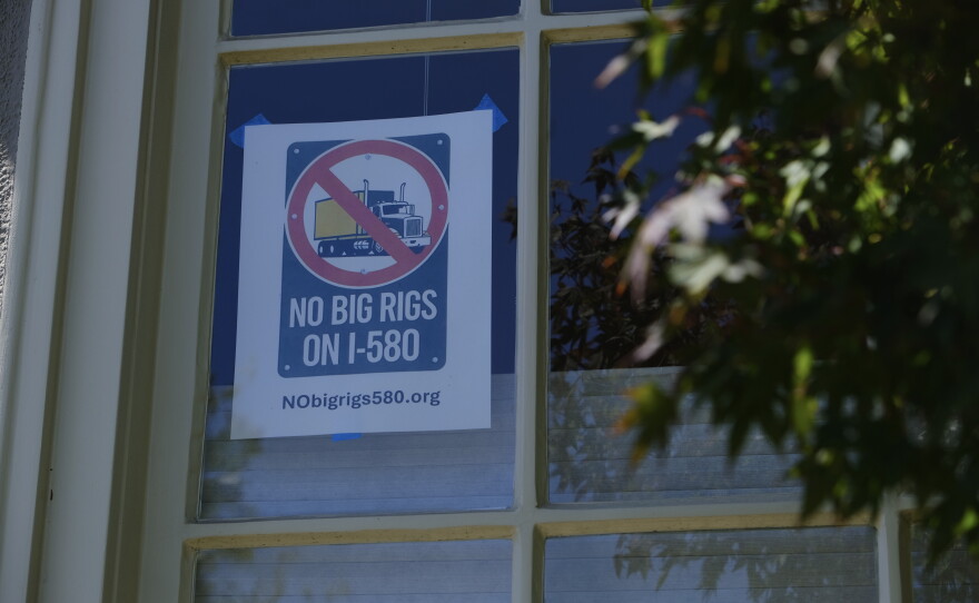 A “NO BIG RIGS ON I-580” poster hangs in the front window of Susan Gallardo’s home in Oakland’s Crocker Highlands neighborhood.