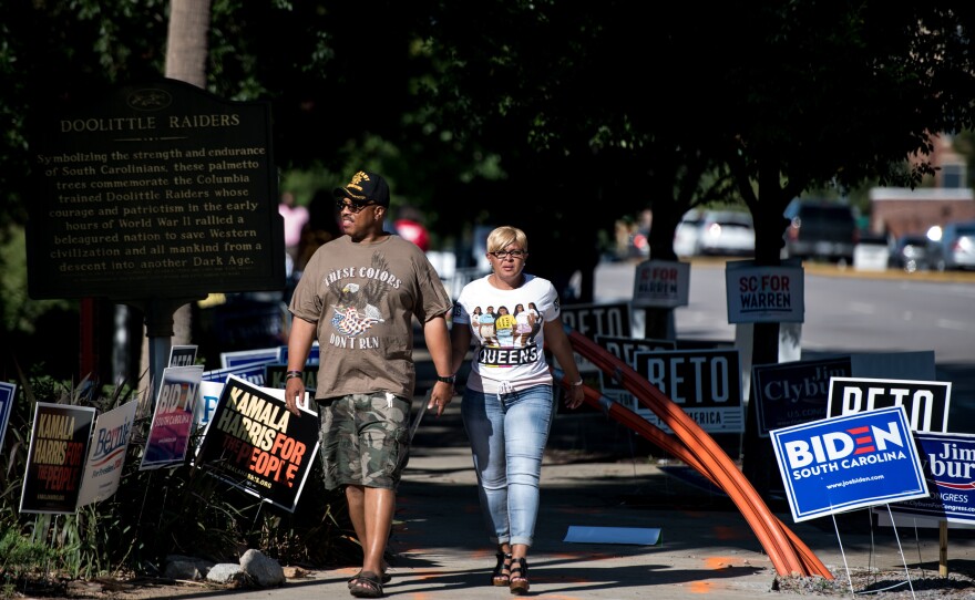 People walk down the sidewalk outside of Jim Clyburn's World-Famous Fish Fry. Unlike Iowa, New Hampshire, and Nevada, in South Carolina's Democratic primary, a majority of votes will be cast by African Americans.