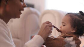 A mom feeds her baby.