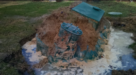A plastic tank floating out of the ground when pumped under flooded/shallow water conditions.