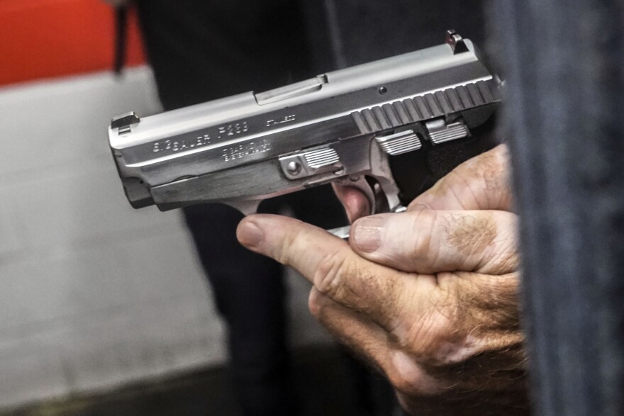 John Deloca, owner of Seneca Sporting Range, prepares to fire his 9mm semi-automatic handgun during a shooting demonstration at his gun range, June 23, 2022, in New York.