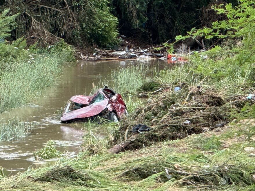 A car and other debris pushed into the creek at Perrin Beitel.