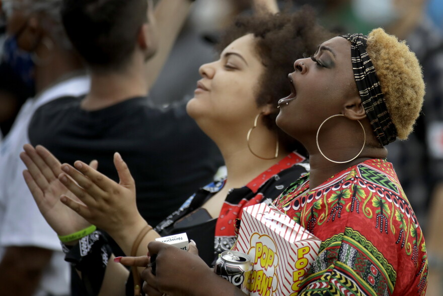 People listen to a speaker at a Juneteenth rally in Tulsa, Okla., Friday, June 19, 2020. Juneteenth marks the day in 1865 when federal troops arrived in Galveston, Texas, to take control of the state and ensure all enslaved people be freed, more than two years after the Emancipation Proclamation. 