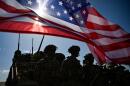 U.S. Army soldiers stand in formation next to a US flag and a U.S. Army armoured vehicle as they take part in the NATO "Noble Blueprint 23" joint military exercise at the Novo Selo military ground, northwestern Bulgaria, on September 26, 2023. (Nikolay Doychinov/AFP via Getty Images)