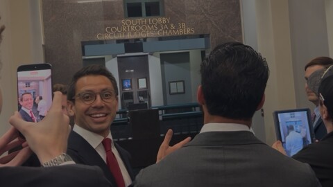 James Fishback smiles as supporters and members of the media record him outside the courtroom following a hearing at the Leon County Courthouse in Tallahassee.