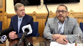 House Speaker Matt Ritter and House Majority Leader Jason Rojas (L-R) talk with reporters Friday May 3, 2024 at the Connecticut Capitol as a bill to create a roadmap for EV's appeared stalled. “I think our state was shocked at how much pushback there was and how woefully unprepared we were for that transition,” Ritter said. “I don't see it getting better by doing nothing. But some people think the commission is not worth it.” (Michayla Savitt/Connecticut Public)