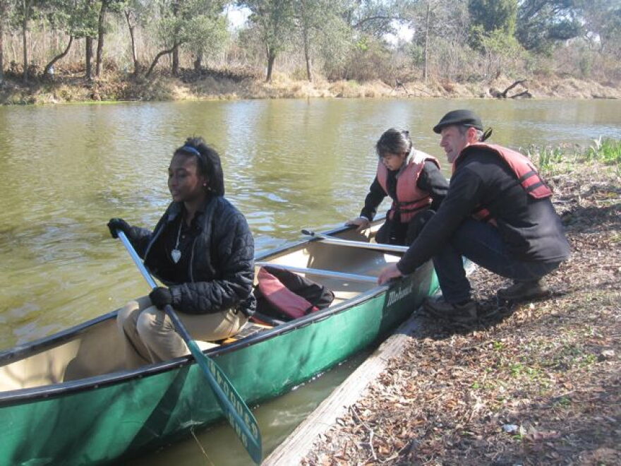 Dan Forman helps middle school students Maritza Zamora and RonDeaja Craig get underway on a City Park lagoon.