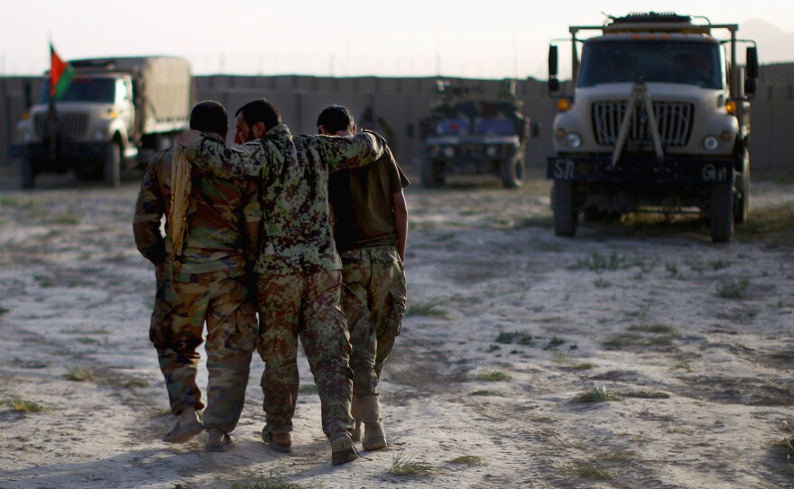 Afghan soldiers return to Camp Eagle after a patrol in Shah Joy district.