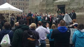ACLU executive director Jane Henegar leads a crowd of more than 100 in the People's Oath, the same President Donald Trump took on Friday.