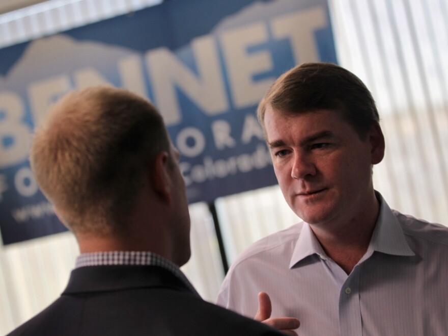 U.S. Sen. Michael Bennet (D-CO) meets with an aide at his campaign headquarters in  Colorado. Bennet was the subject of an attack ad paid for by American Crossroads.