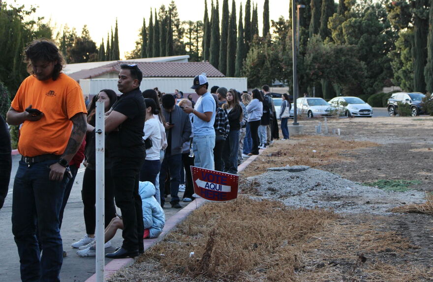 Voters line up outside St. Patrick's Catholic Church in Merced, Calif.
