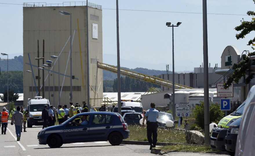 French security and emergency services gather at the entrance of the Air Products factory in Saint-Quentin-Fallavier, near Lyon, on Friday.