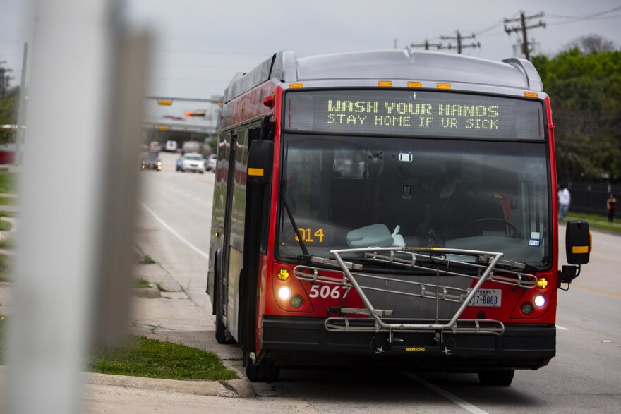 A Cap Metro bus displays a message advising people to wash their hands and stay home if they're sick to help stop the spread the coronavirus.