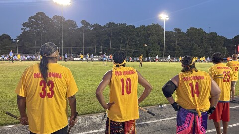 Members of Oka Homa's stickball team stand on the sidelines during the championship game of the 35 and Older division of the World Series of Stickball in Choctaw, Mississippi, on July 18, 2026.
