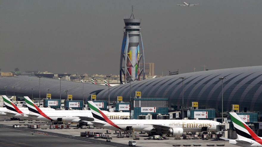 Emirates passenger planes are parked at their gates at the Dubai International Airport in the United Arab Emirates. The U.S. is imposing new restrictions that require most electronic devices, including laptops, tablets and cameras, to be placed in checked baggage on direct flights to the U.S. from eight mostly Muslim countries, including the UAE. Passengers can still carry smartphones.