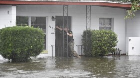 Homes were flooded in the Orlo Vista subdivision during Hurricane Ian. Here an Orange County sheriff's deputy checks on residents.