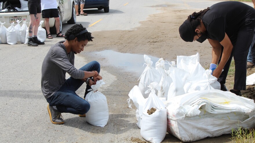 New Orleans residents pack sandbags as they prepare to ride out the storm. Some residents are reliving trauma from Hurricane Katrina.