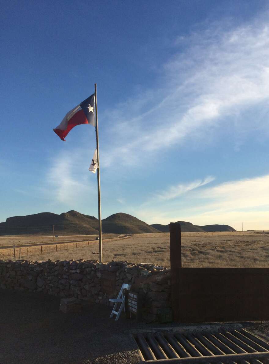 The Texas flag flies above the gate at Cibolo Creek Ranch on Feb. 13.