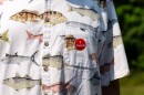 An "I Voted" sticker is placed on the breast pocket of the fish-themed shirt of a voter Aug. 11, 2026, at Woodrow Town Hall in Cass County.