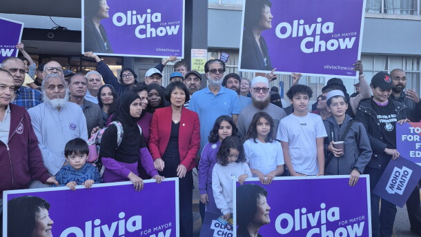 Mayor Olivia Chow poses with condo residents and campaign signs during election season