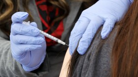 A woman receives a booster shot at a pop-up vaccination clinic in Las Vegas on Dec. 21.