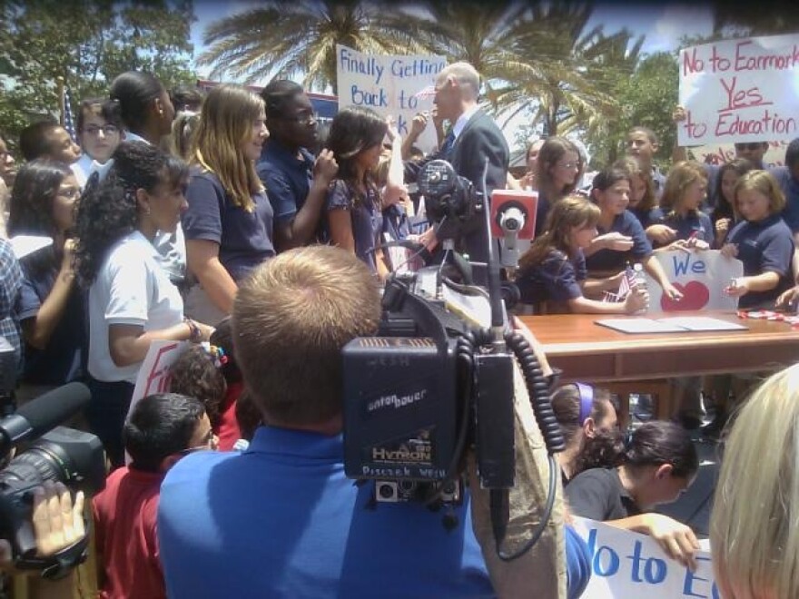 Gov. Scott shakes hands with local students as he prepares to sign the budget.