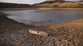 A buoy rests on the ground at a closed boat ramp on Lake Mead at the Lake Mead National Recreation Area near Boulder City, Nev., on Aug. 13, 2021. To help stave off another round of mandatory cutbacks, water leaders for Arizona, Nevada and California are preparing to sign an agreement on Wednesday, Dec. 15, 2021, that would voluntarily reduce water to the lower Colorado River basin states by 500,000 acre-feet for both 2022 and 2023.