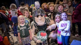 Sparty with kids holding "I heart WKAR" sign