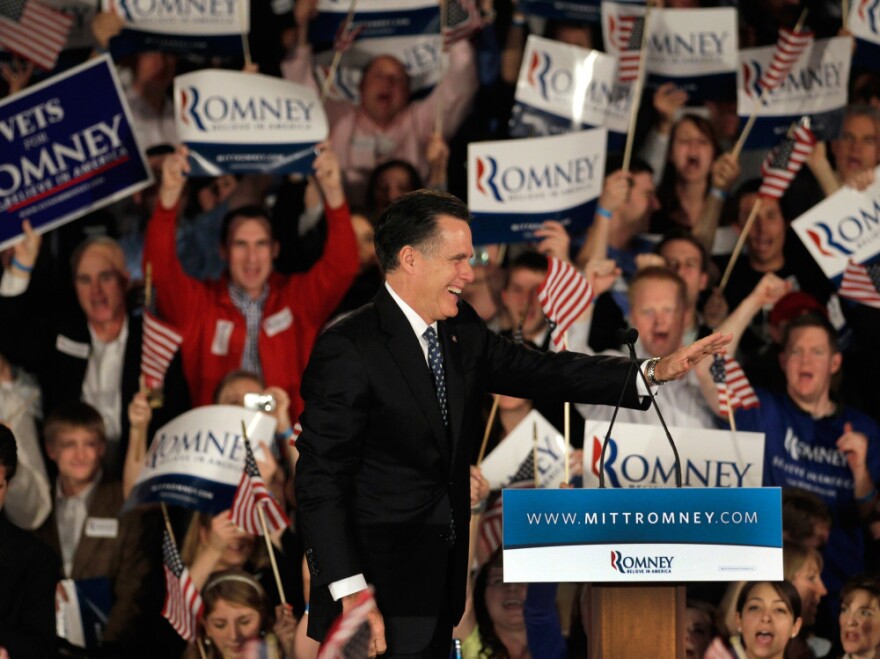 Republican presidential candidate Mitt Romney waves as he takes the stage during his primary night rally Saturday in Columbia, S.C.