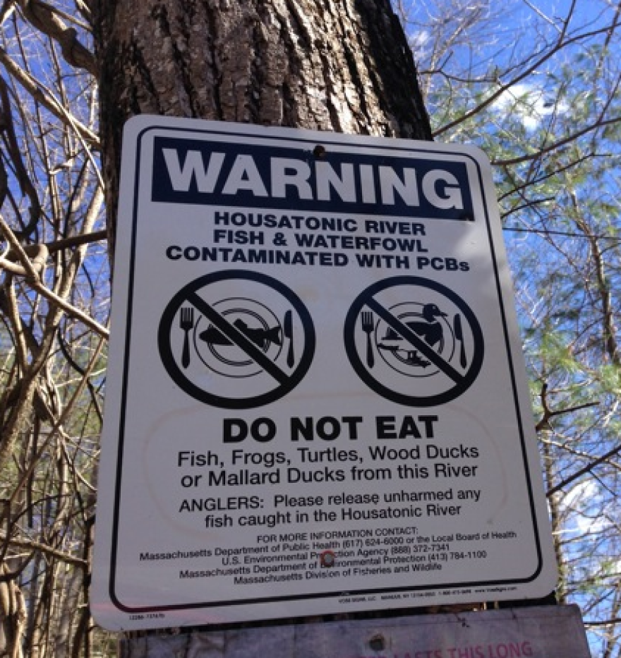 In a file photo, a fish advisory is posted next to a path to a fishing spot on the Housatonic River.