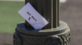 A paper envelope was written with the words "Rent Money $" is left tucked in a lighting pole in the Boyle Heights east district of the city of Los Angeles, Wednesday, April 1, 2020.