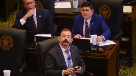 Copan Republican Rep. Judd Strom, center, watches the teleprompter showing House member votes on legislation during the afternoon floor session on March 11, 2025, at the Oklahoma State Capitol. Behind him, deputy floor leaders Steve Bashore from Miami, top left, and John Pfeiffer, top right, from Orlando also watch the screen.