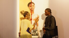 Artist Dafe Oboro (right), winner of the Nigerian Prize Award of the Access ART X Prize 2022/23, chats with an attendee at this year's Art X fair in Lagos.