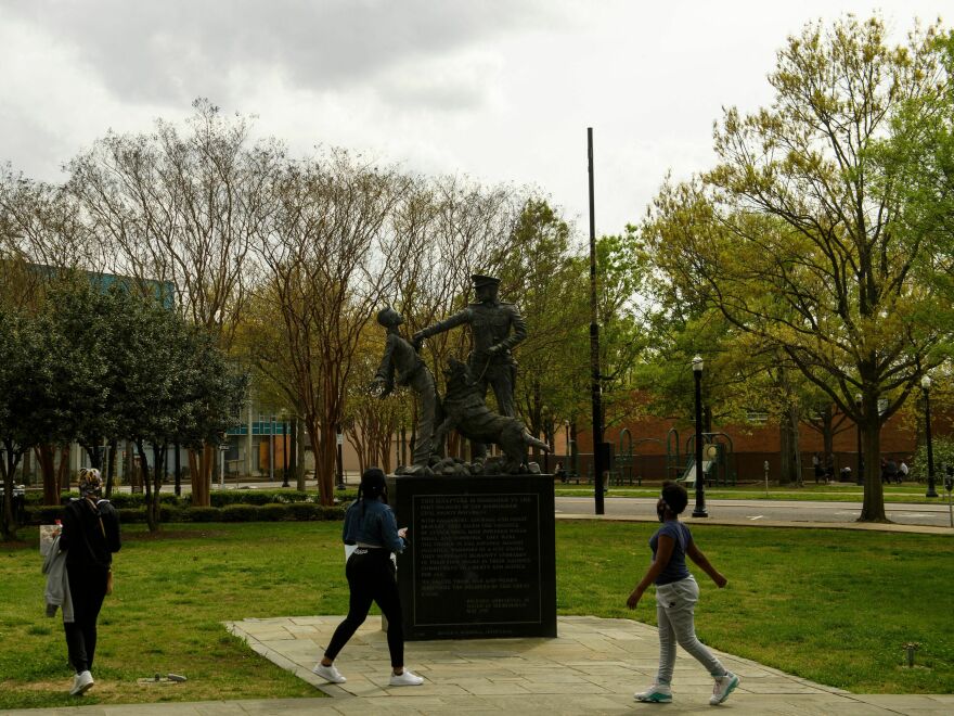 People look at a sculpture marking the Children's Crusade, across from the 16th Street Baptist Church, a Civil Rights historical site at Kelly Ingram Park on March 27, 2021 in Birmingham, Ala.