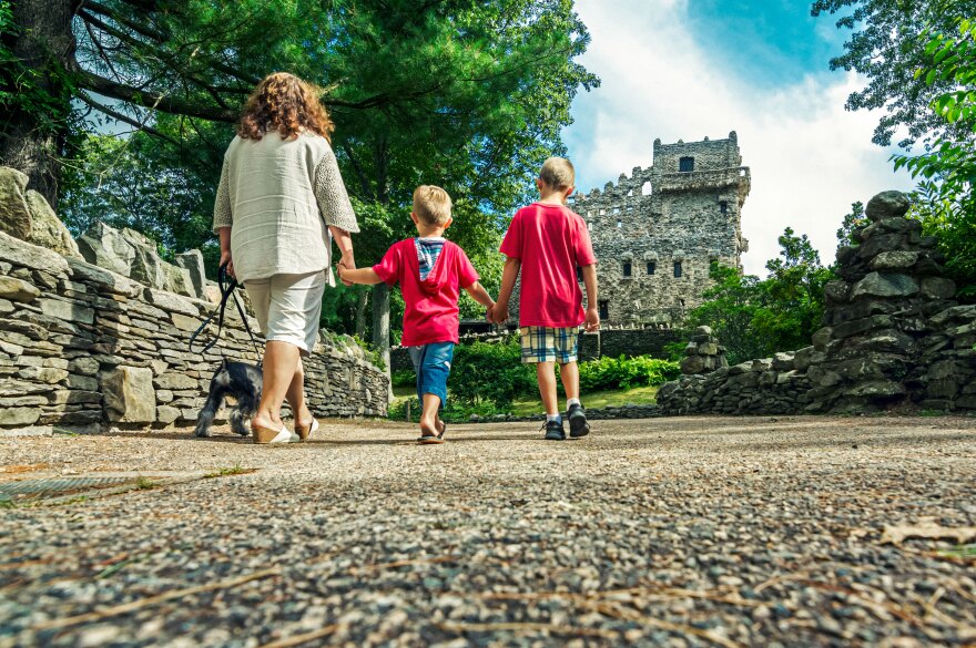 File: A family taking a  walk at Gillette Castle State Park in East Haddam, Connecticut on a sunny day.