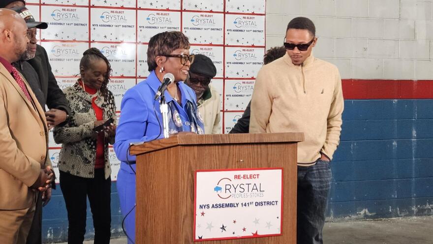 State Assembly Majority Leader Crystal Peoples-Stokes, behind lectern, announces she won't seek re-election in the fall.