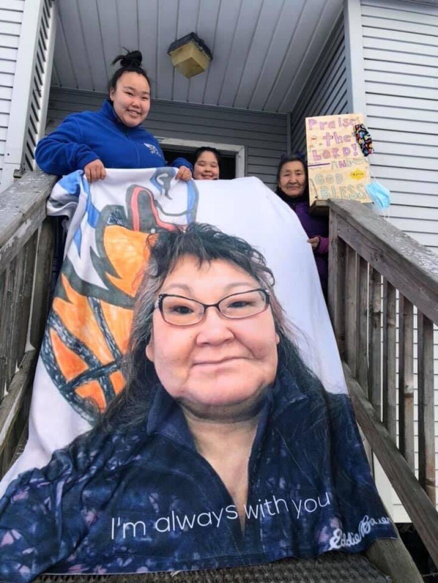 Bertha Black's daughter-in-law, Charlotte Black, holding a blanket with Bertha's image on it during the Blue/Purple drive for David Aqvang Evon and Bertha Black.