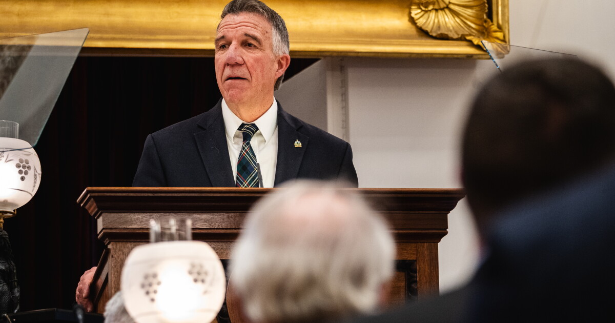 Photo: vermontpublic.org A man wearing a suit stands at a podium